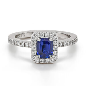 18ct White Gold Emerald Cut Sapphire with Diamond Surround and Diamond Shoulders Ring